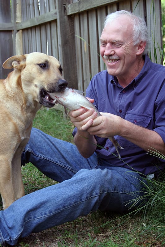 Whistleblower Vet Tom Lonsdale feed a pup a raw, whole fish.